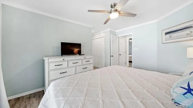 a bedroom with a bed and a television