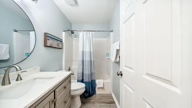 a bathroom with a toilet a sink and a mirror