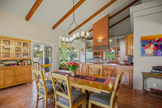 a dining room with furniture a rug and wooden floor