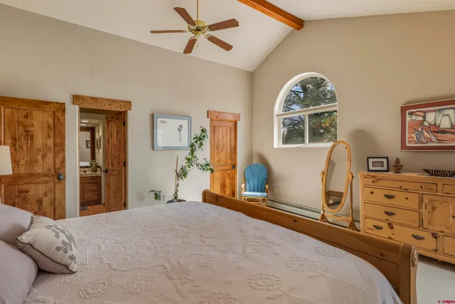 a bedroom with a bed and a dresser