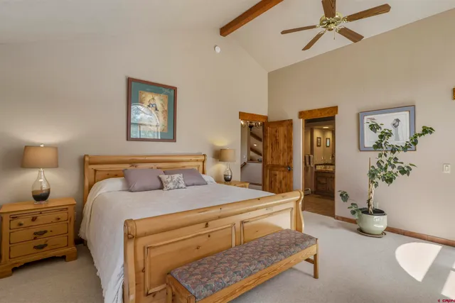 a bedroom with a bed and ceiling fan