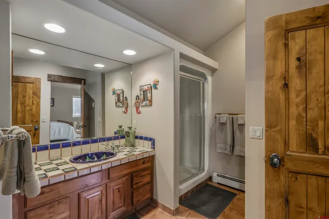 a bathroom with a double vanity sink and a mirror