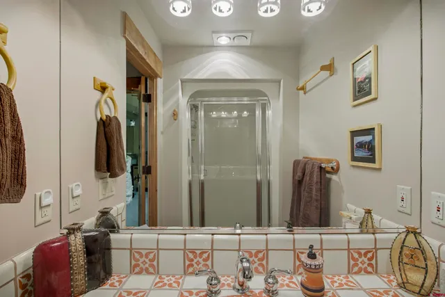 a bathroom with a mirror and a sink