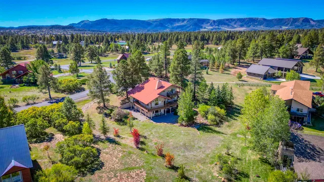 a view of a house with a yard and a garden