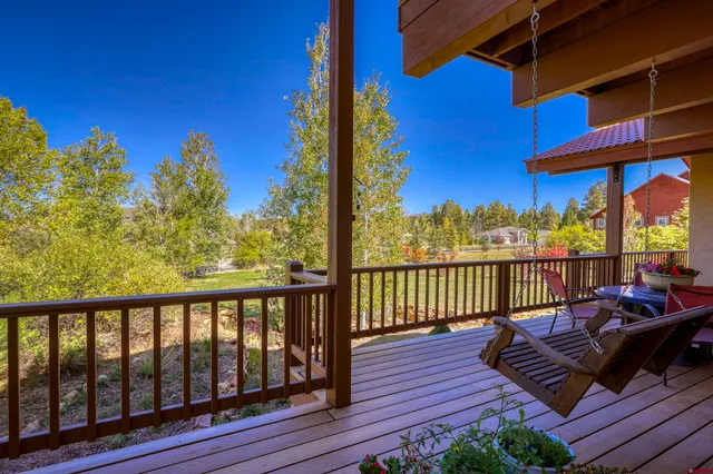 a view of a balcony with wooden floor