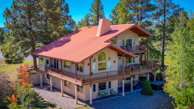 a front view of house with yard and trees around