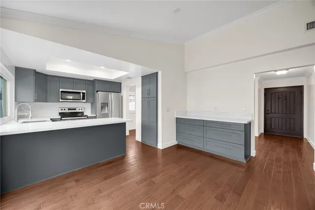 a view of kitchen with sink and wooden floor