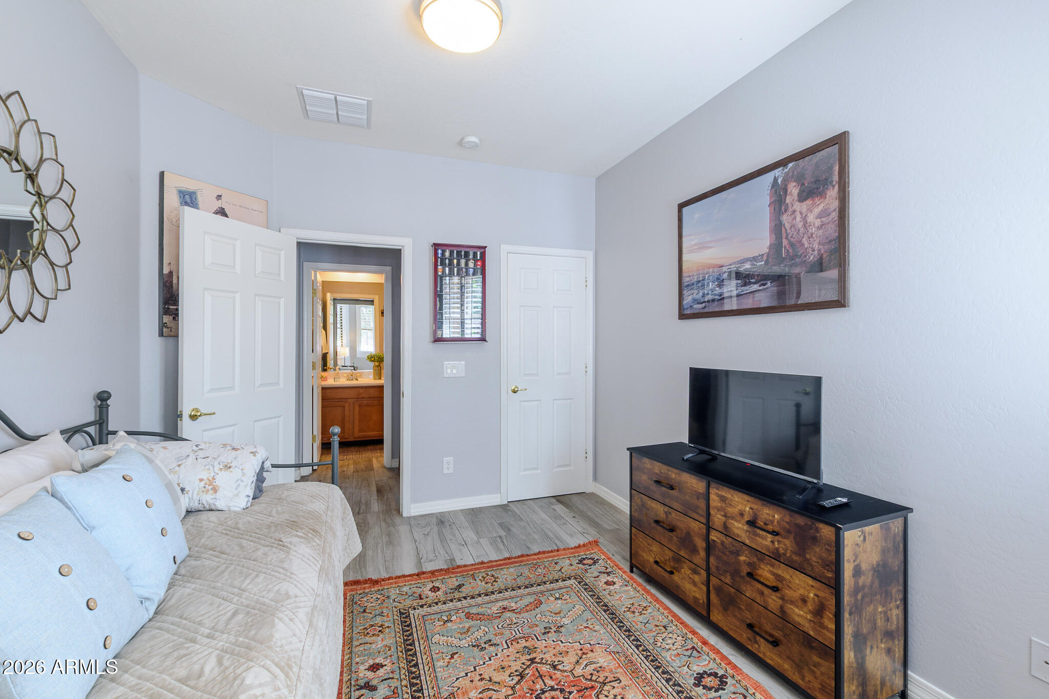 4521 West Moss Springs Road Anthem, AZ 85086 - Photo 21 of 35 a bed room with a bed and a television