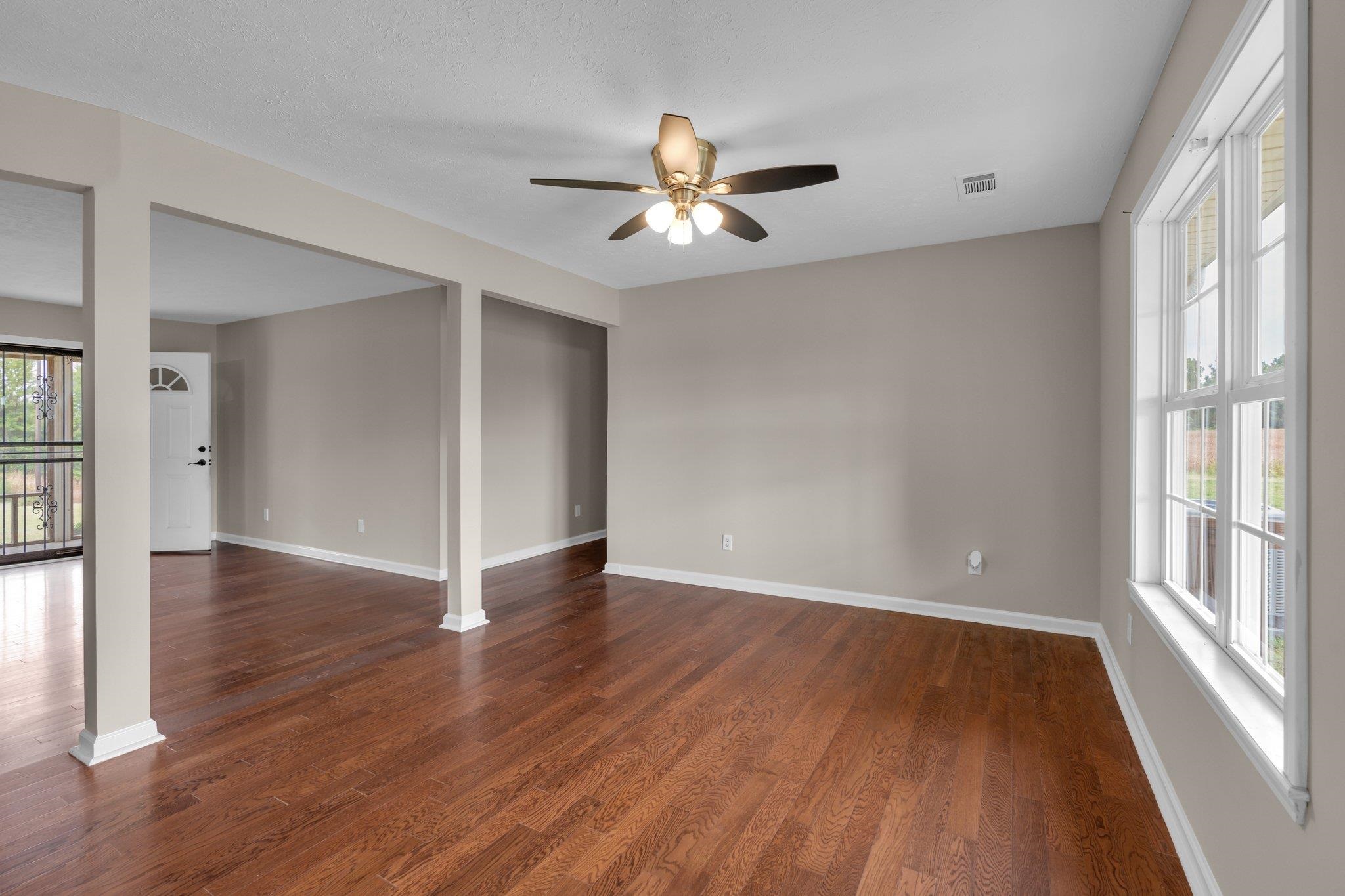 276 Mcbroom Road Henning, TN 38041 - Photo 11 of 36 Empty room with ceiling fan and dark hardwood / wood-style floors