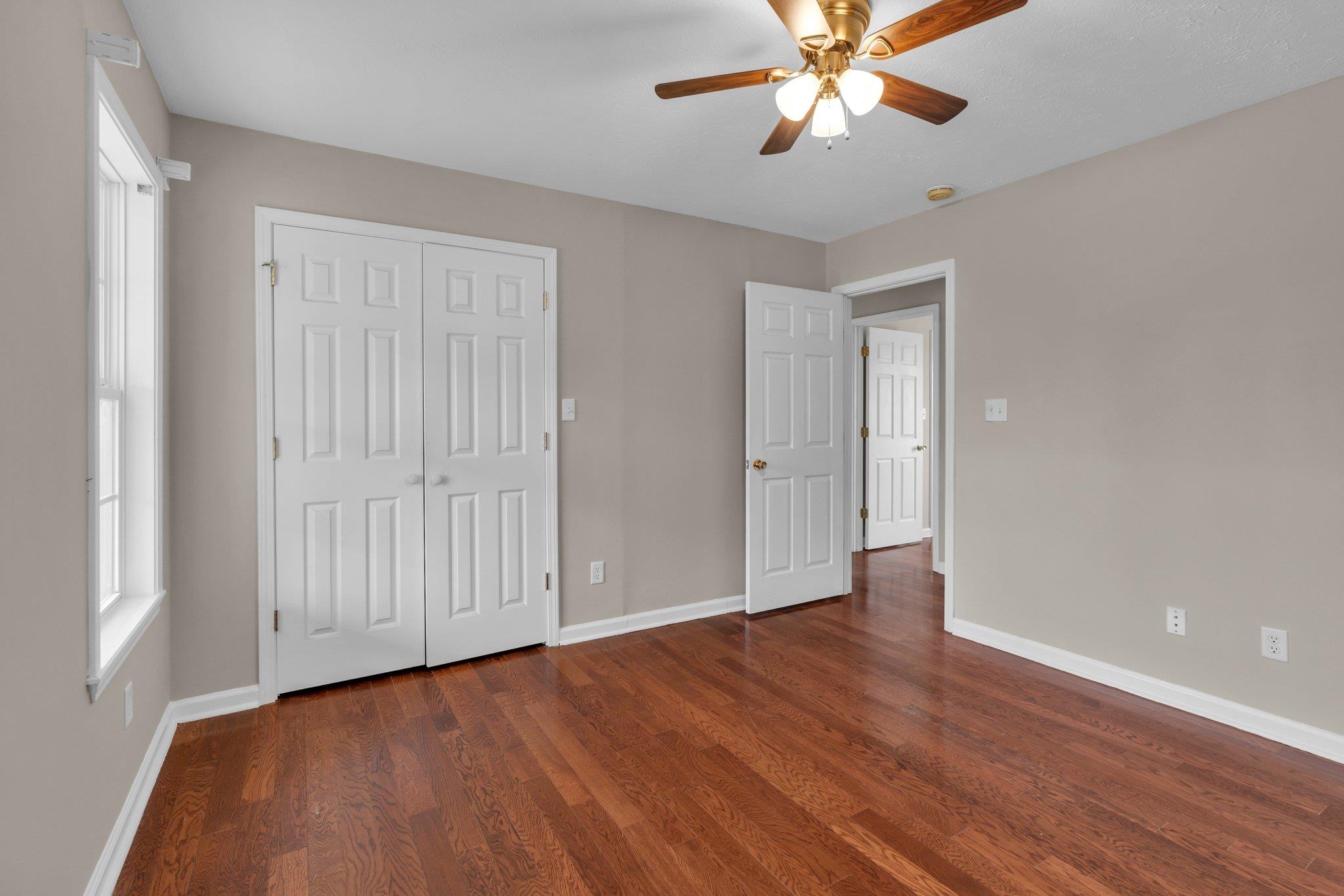 276 Mcbroom Road Henning, TN 38041 - Photo 25 of 36 Unfurnished bedroom with dark wood-type flooring, ceiling fan, and a closet