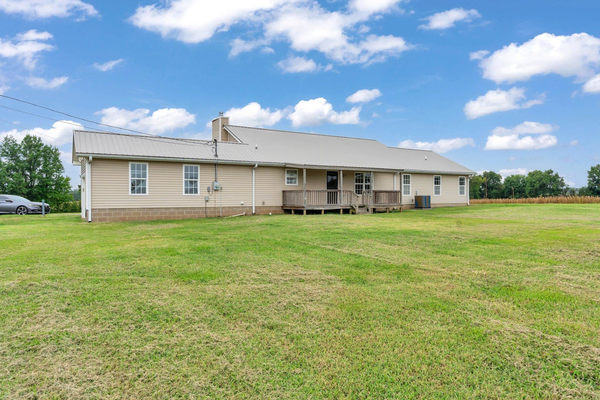 276 Mcbroom Road Henning, TN 38041 - Photo 29 of 36 Rear view of property with central AC, a lawn, and a deck