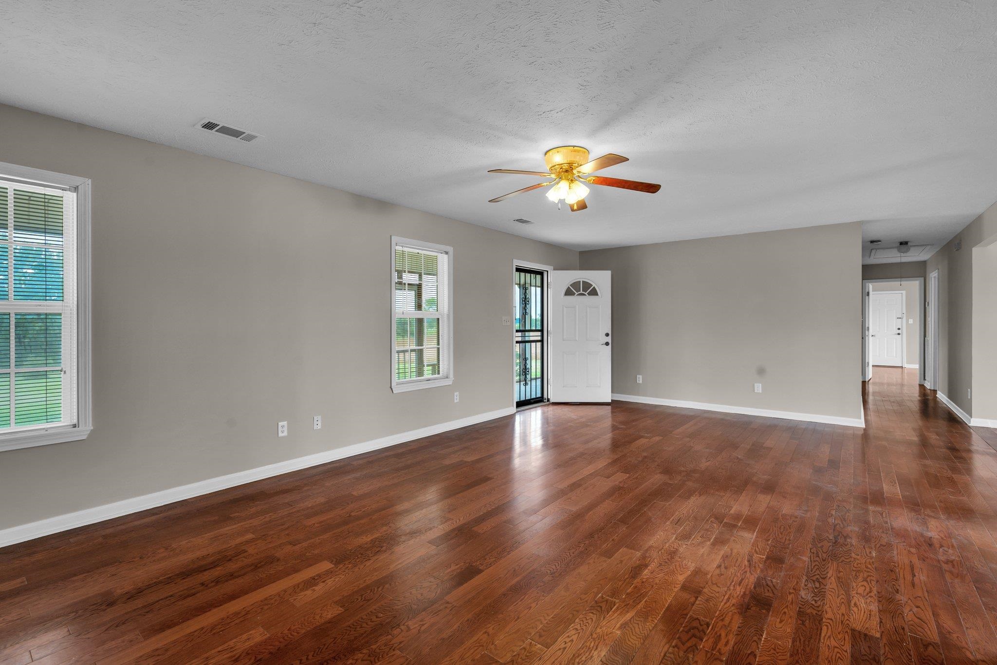 276 Mcbroom Road Henning, TN 38041 - Photo 8 of 36 Spare room featuring a textured ceiling, dark wood-type flooring, and ceiling fan
