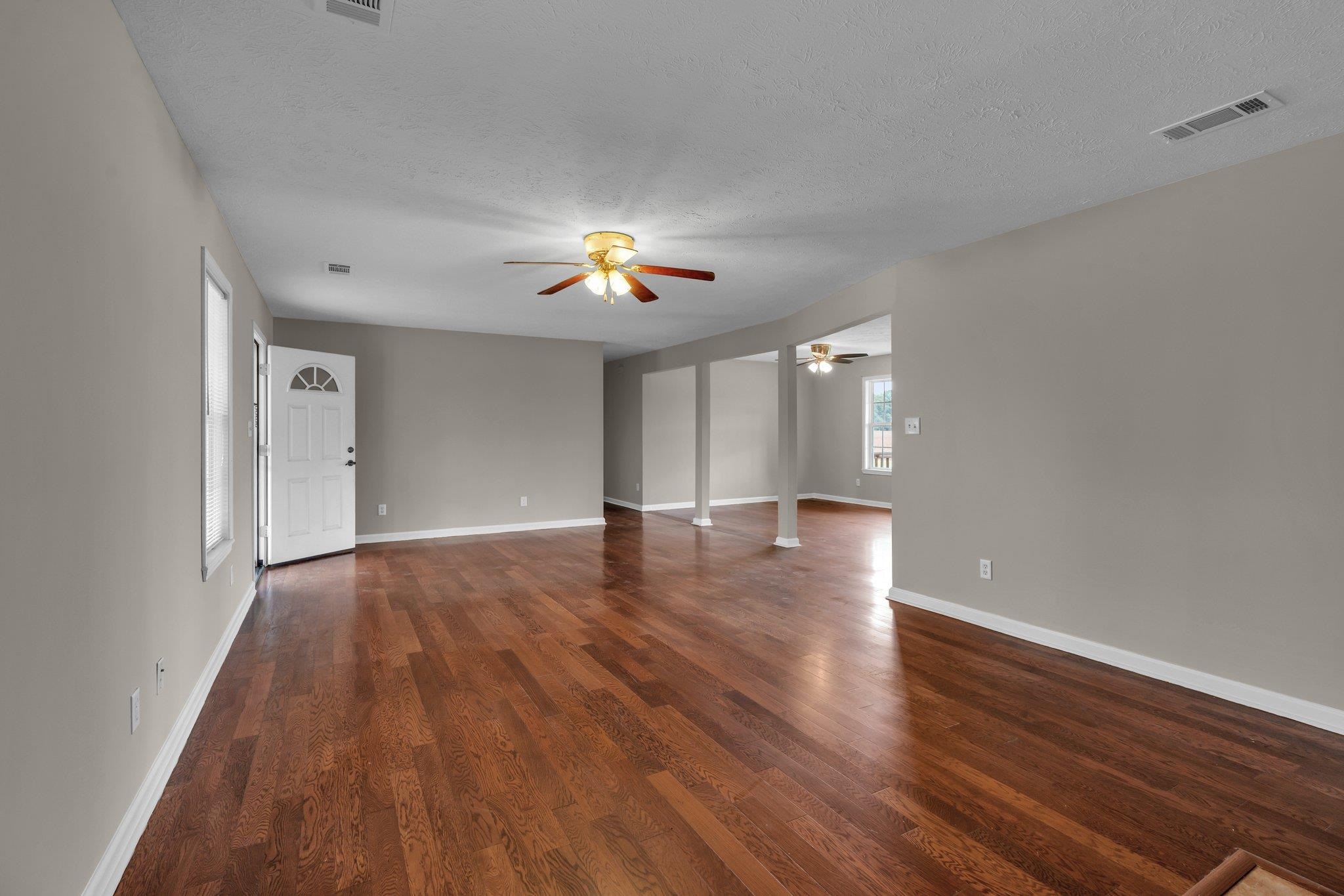276 Mcbroom Road Henning, TN 38041 - Photo 9 of 36 Spare room with ceiling fan, dark hardwood / wood-style flooring, and a textured ceiling