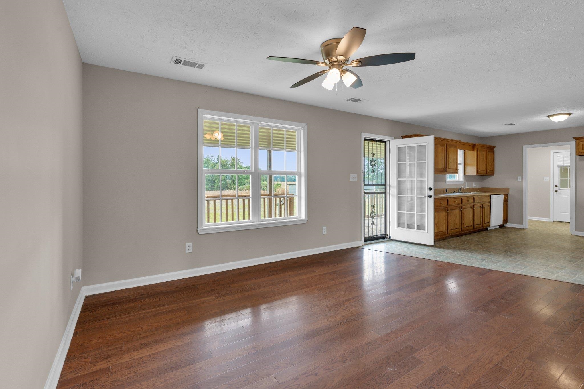 276 Mcbroom Road Henning, TN 38041 - Photo 10 of 36 Unfurnished living room with hardwood / wood-style flooring and ceiling fan