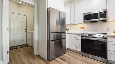 a kitchen with a stove microwave and refrigerator