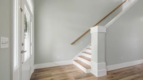 a view of entryway and hall with wooden floor