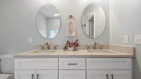 a bathroom with a double vanity sink and a mirror