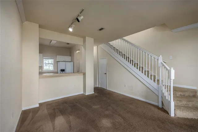 a view of a hallway view with staircase