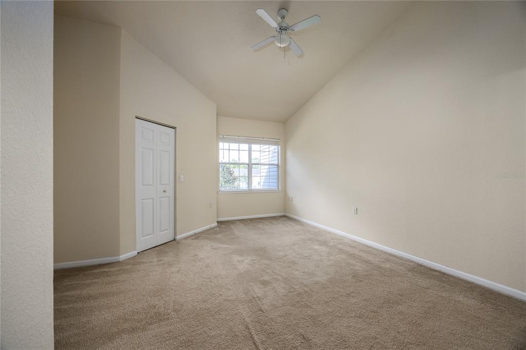 4872 Northwest 42nd Road, Unit 105 Gainesville, FL 32606 - Photo 19 of 38 an empty room with a window and ceiling fan