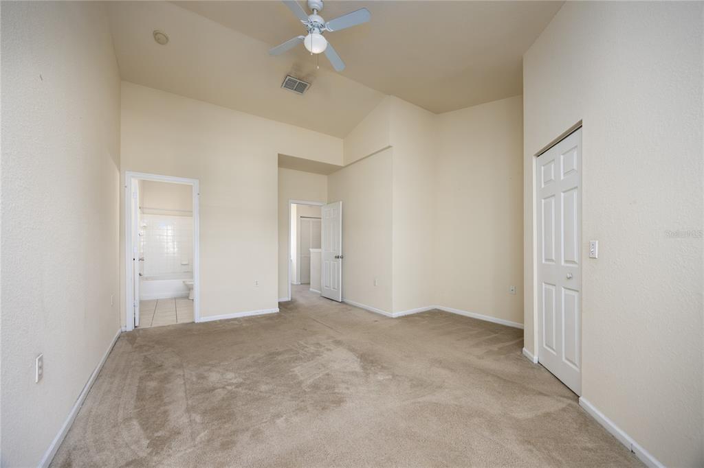 4872 Northwest 42nd Road, Unit 105 Gainesville, FL 32606 - Photo 20 of 38 an empty room with a ceiling fan and closet area