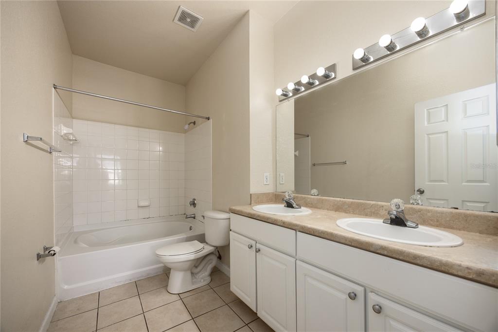 4872 Northwest 42nd Road, Unit 105 Gainesville, FL 32606 - Photo 21 of 38 a bathroom with a sink a toilet and shower