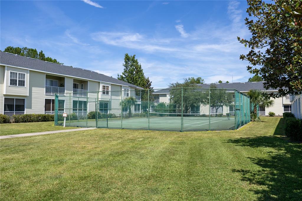 4872 Northwest 42nd Road, Unit 105 Gainesville, FL 32606 - Photo 27 of 38 a view of a house with a big yard and potted plants