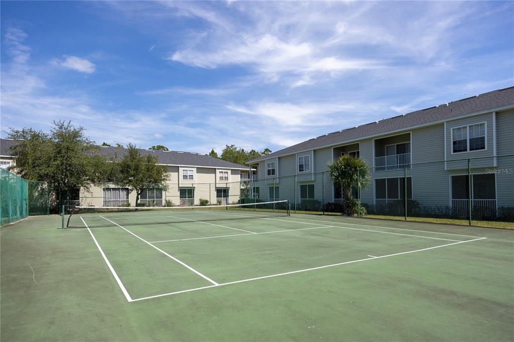 4872 Northwest 42nd Road, Unit 105 Gainesville, FL 32606 - Photo 28 of 38 a view of a tennis ground with large trees