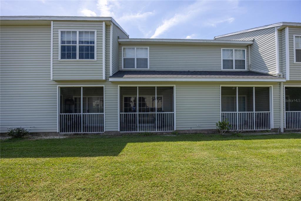 4872 Northwest 42nd Road, Unit 105 Gainesville, FL 32606 - Photo 30 of 38 a view of a house with a yard and large window