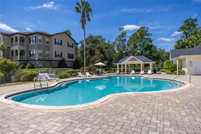 a front view of house with outdoor space and swimming pool