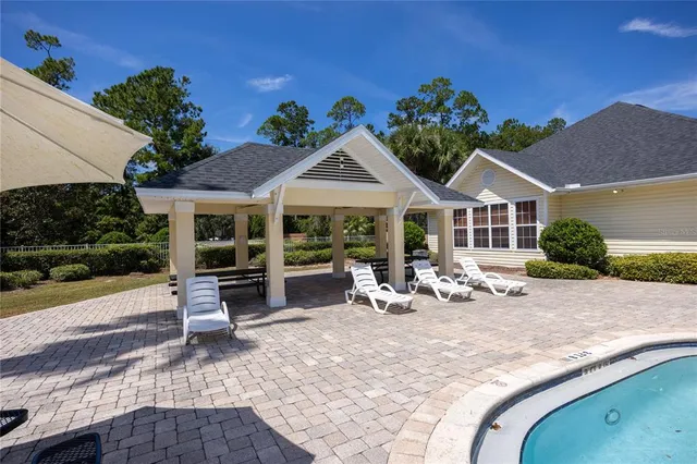 a living room with fireplace furniture and a large window or chandelier
