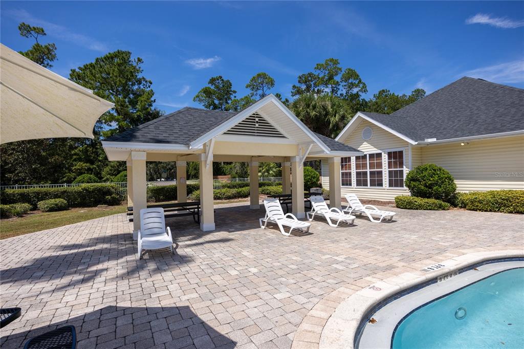 4872 Northwest 42nd Road, Unit 105 Gainesville, FL 32606 - Photo 36 of 38 a view of a house with wooden floor and outdoor seating