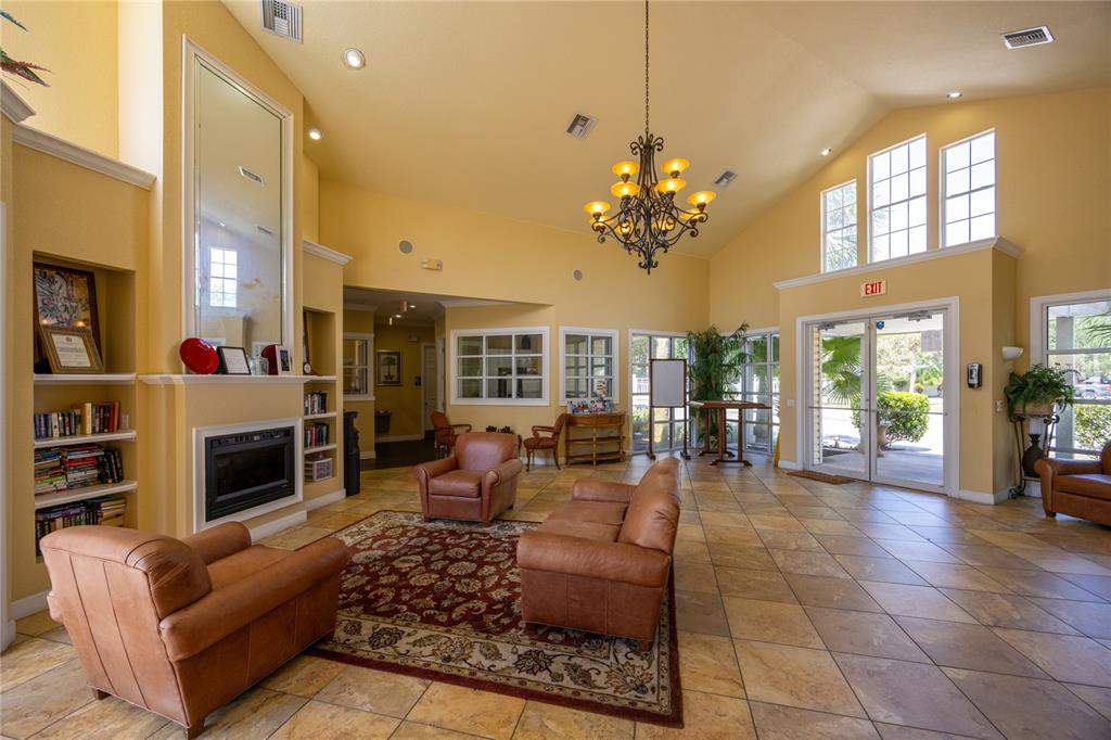 4872 Northwest 42nd Road, Unit 105 Gainesville, FL 32606 - Photo 37 of 38 a living room with fireplace furniture and a large window or chandelier
