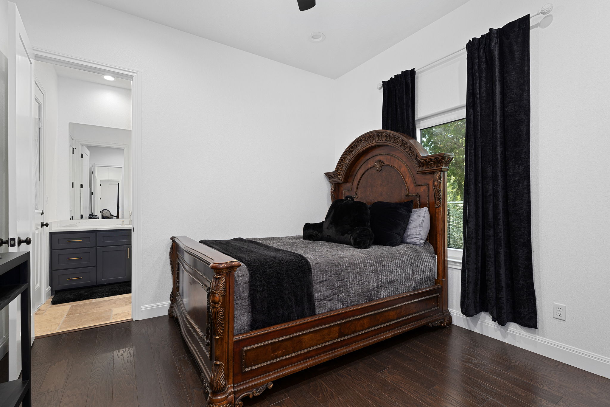 153 Fawn Hollow Elgin, TX 78621 - Photo 29 of 40 a bedroom with a bed and wooden floor