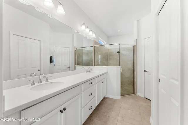 a bathroom with a double vanity sink and mirror