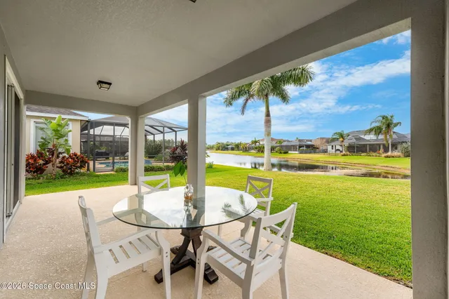 a view of a patio with a table chairs and garden
