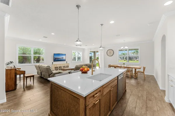 a living room with furniture wooden floor and a flat screen tv