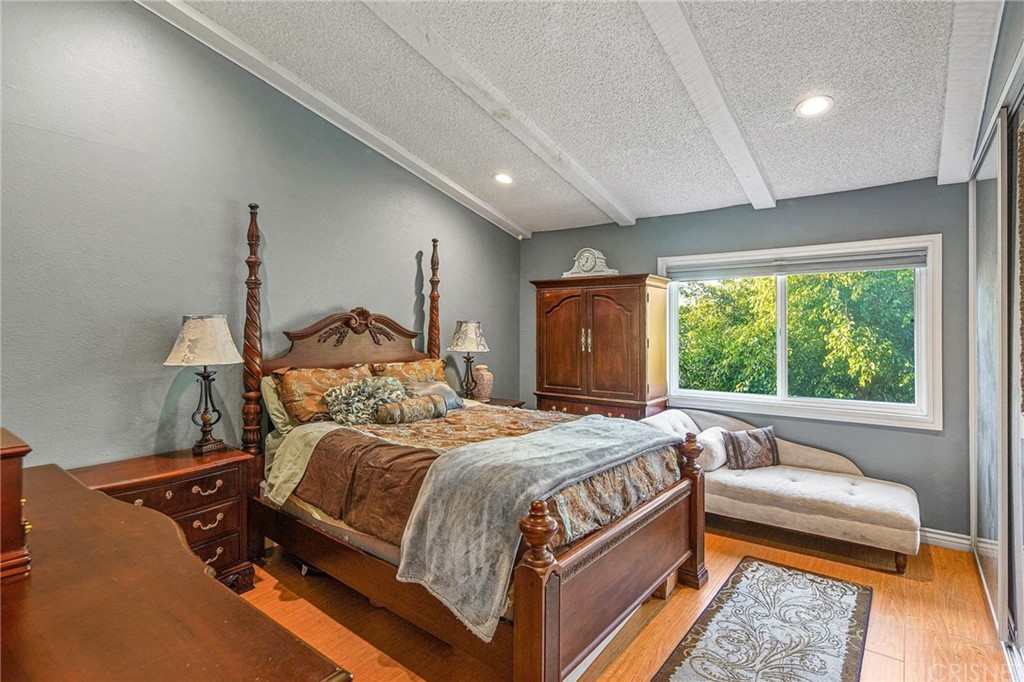 7320 Lennox Avenue, Unit H1 Van Nuys, CA 91405 - Photo 13 of 20 a bedroom with a bed and a large window