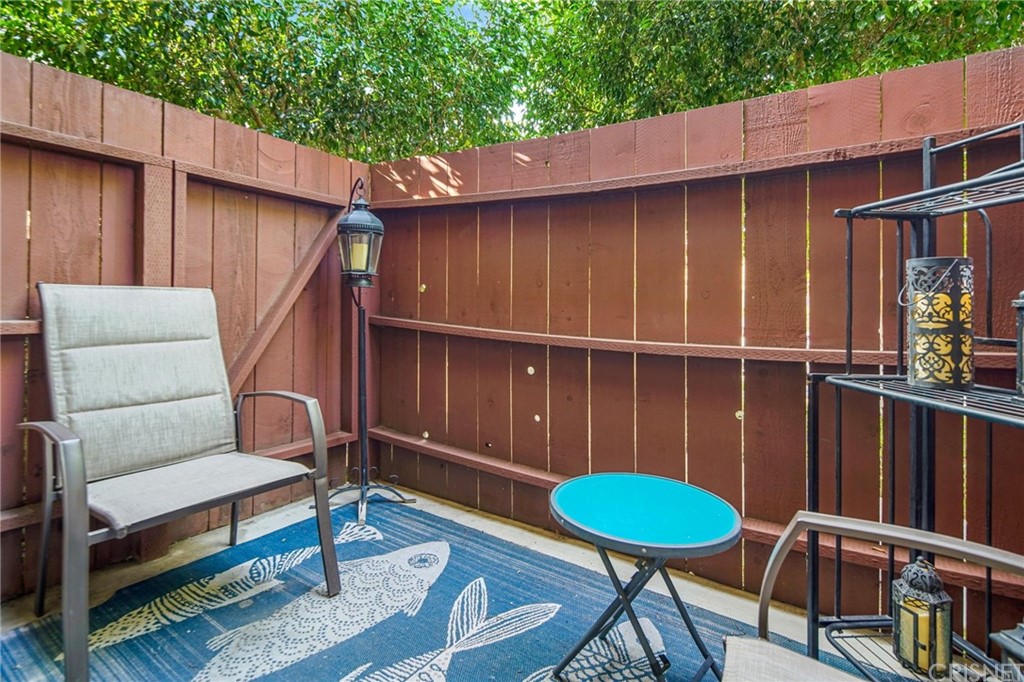 7320 Lennox Avenue, Unit H1 Van Nuys, CA 91405 - Photo 18 of 20 a backyard of a house with wooden floor a barbeque oven and outdoor seating