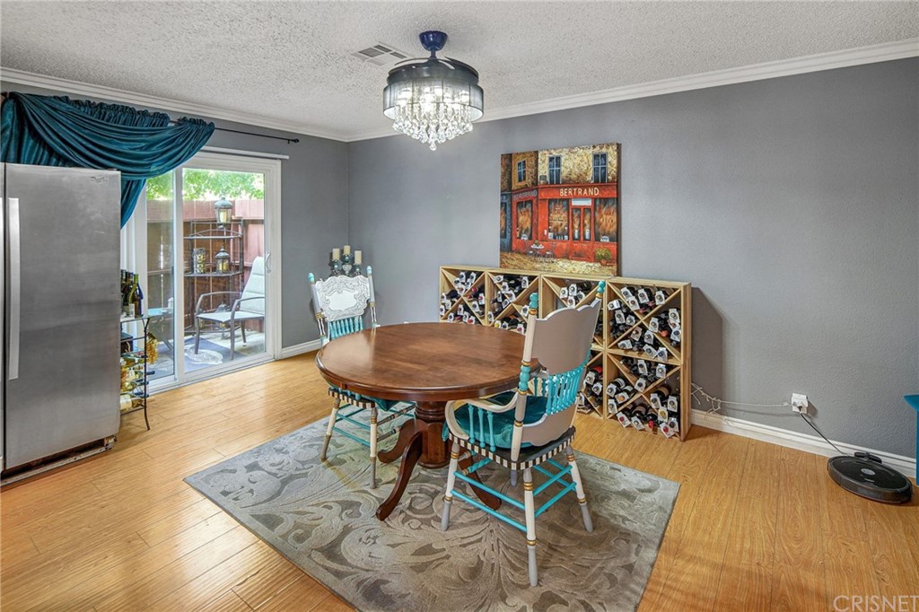 7320 Lennox Avenue, Unit H1 Van Nuys, CA 91405 - Photo 8 of 20 a view of a dining room with furniture and chandelier
