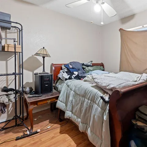 a bed sitting in a bedroom next to a window