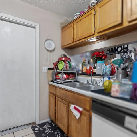 a kitchen with stainless steel appliances granite countertop a sink a stove and a microwave