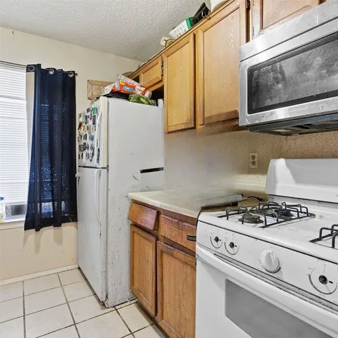 a kitchen with stainless steel appliances granite countertop a refrigerator and a stove
