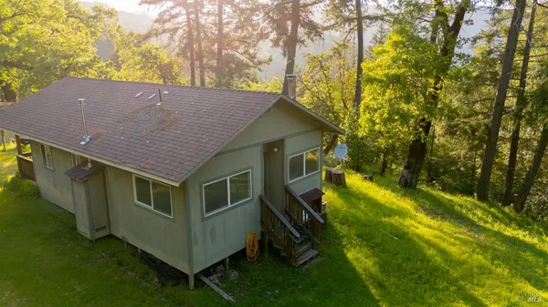 a view of a house with pool and a yard