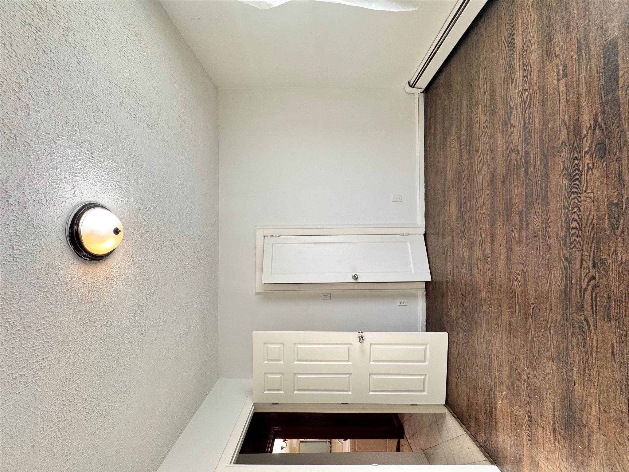 259-07 147th Road Queens, NY 11422 - Photo 4 of 24 1st floor bedroom with baseboards, dark wood-style flooring, and a textured ceiling