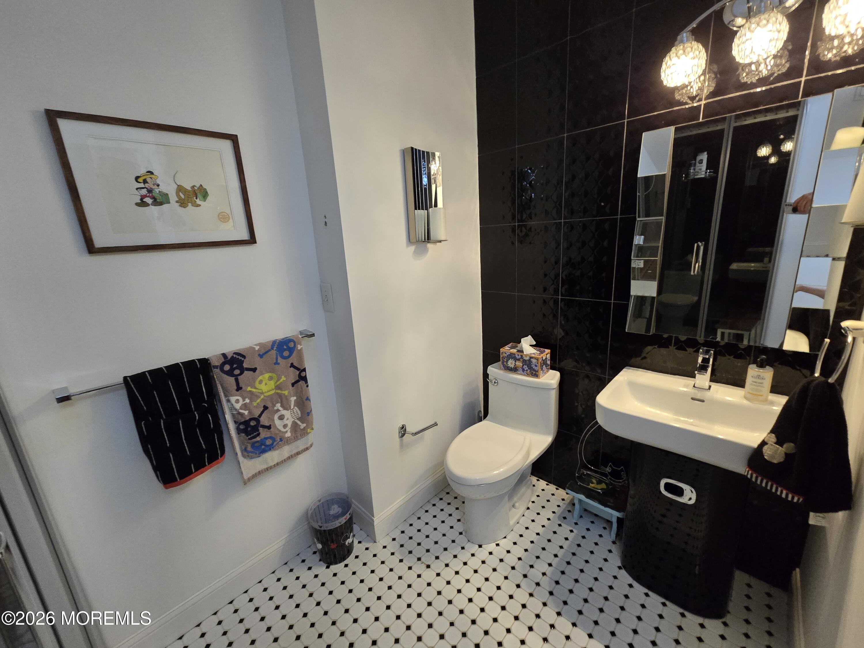 112 Beacon Hill Road Morganville, NJ 07751 - Photo 46 of 53 a bathroom with a sink toilet and a mirror