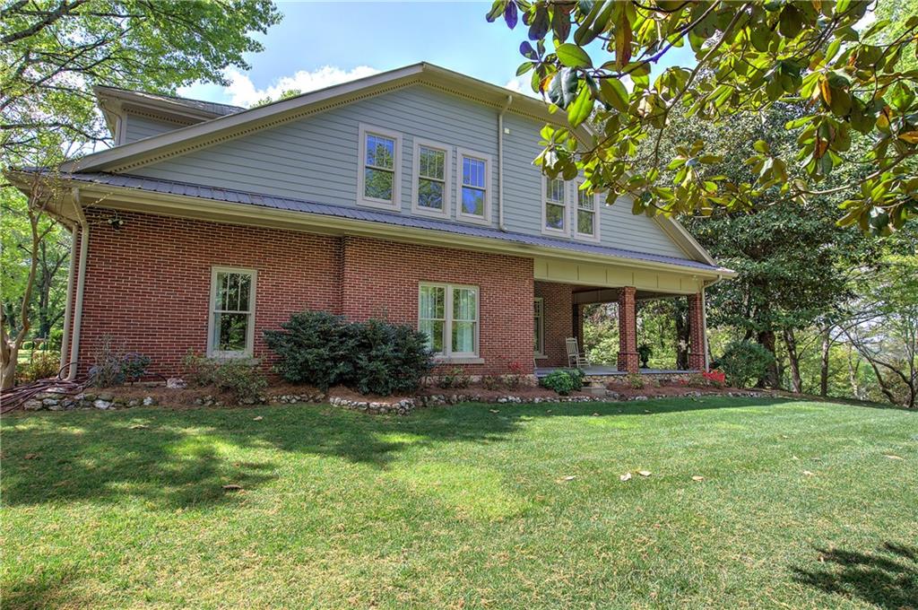 421 Boulevard Heights Calhoun, GA 30701 - Photo 11 of 96 a front view of a house with a yard and garage