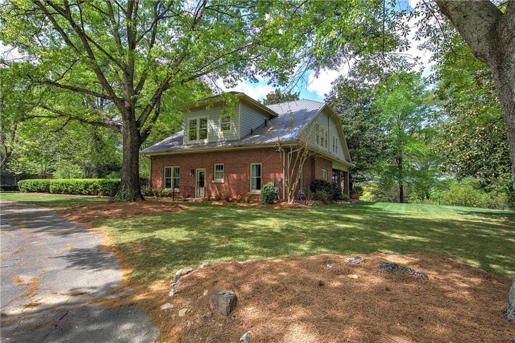 421 Boulevard Heights Calhoun, GA 30701 - Photo 17 of 96 a front view of a house with a garden