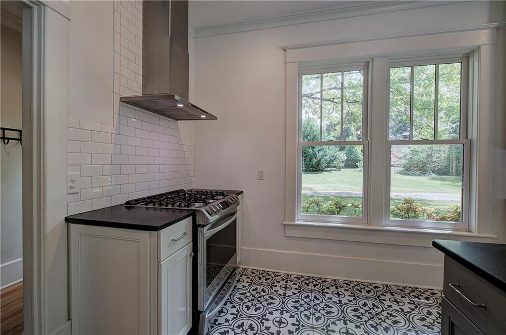 421 Boulevard Heights Calhoun, GA 30701 - Photo 27 of 96 a kitchen with a stove a sink and a window