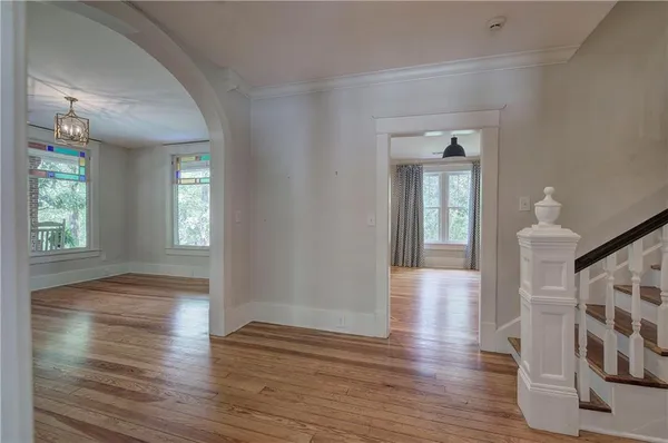 a view of a hallway with wooden floor and staircase