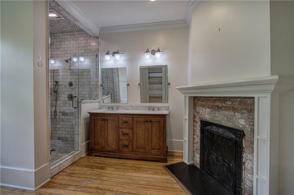 421 Boulevard Heights Calhoun, GA 30701 - Photo 48 of 96 a spacious bathroom with a granite countertop sink a mirror and shower